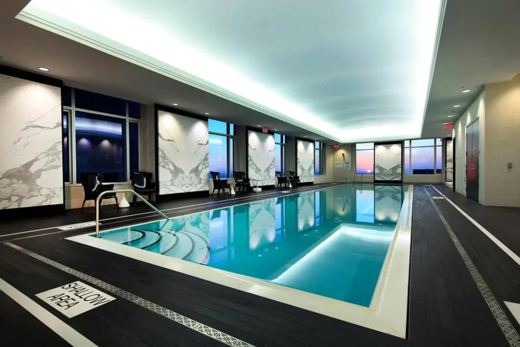 blue back-lit high gloss stretch ceiling in swimming pool area