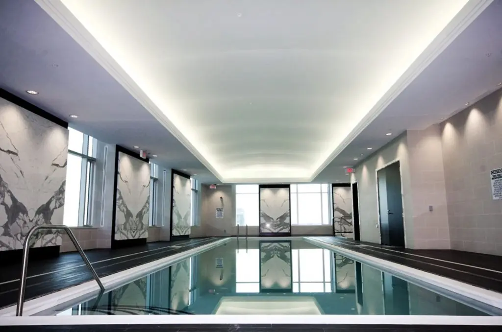 back lit reflective stretch ceiling and custom wall cover pool area