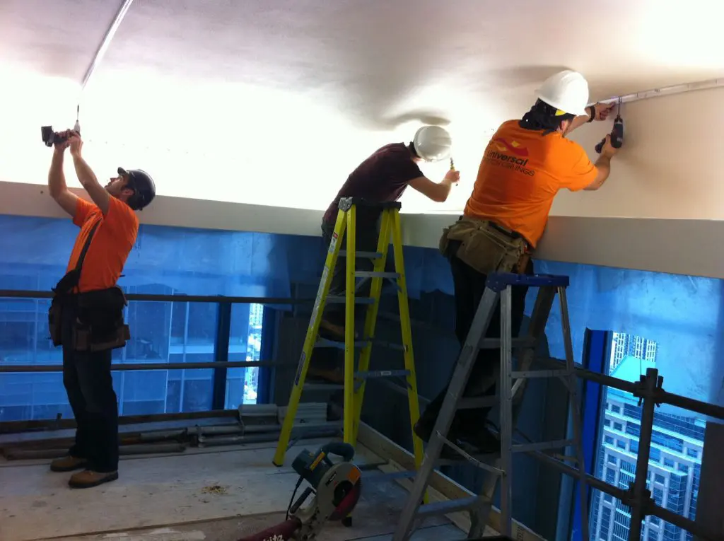 laqfoil team is working on installing stretch fabric in hotel