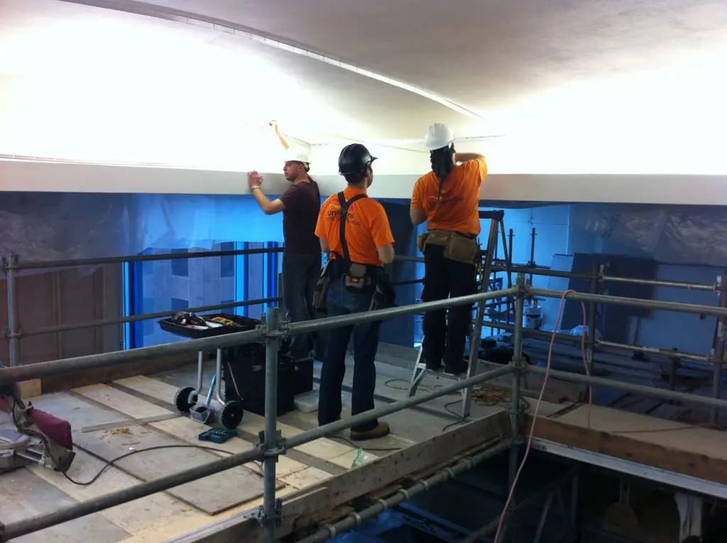 laqfoil team installing stretch ceiling in swimming pool area